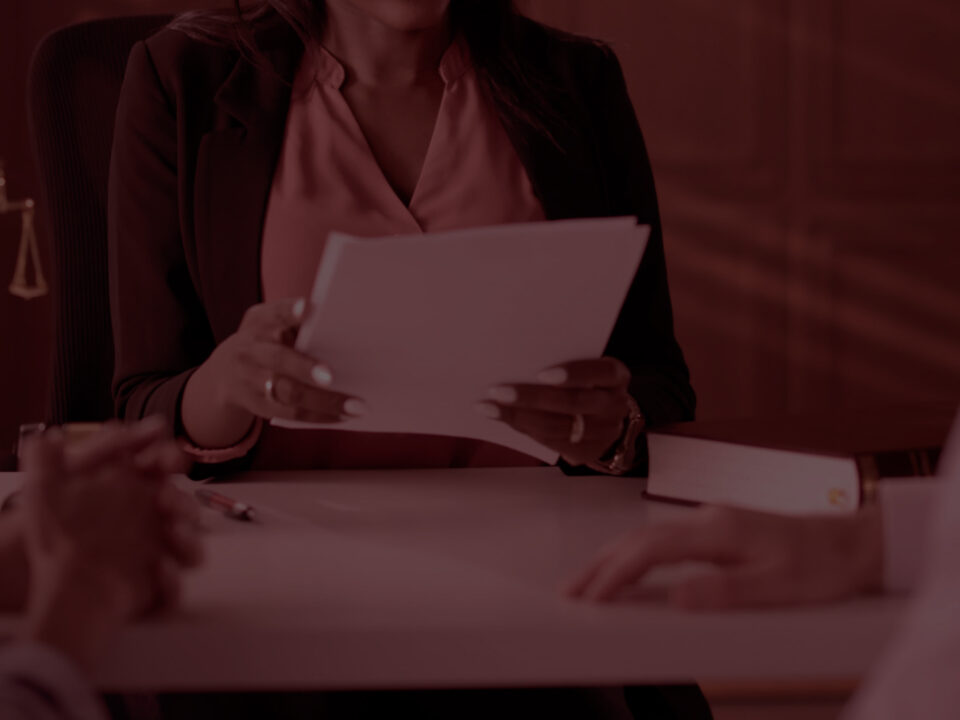 Woman reviewing documents with a couple